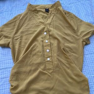 Beautiful yellow shirt with short sleeves. Very soft and new.